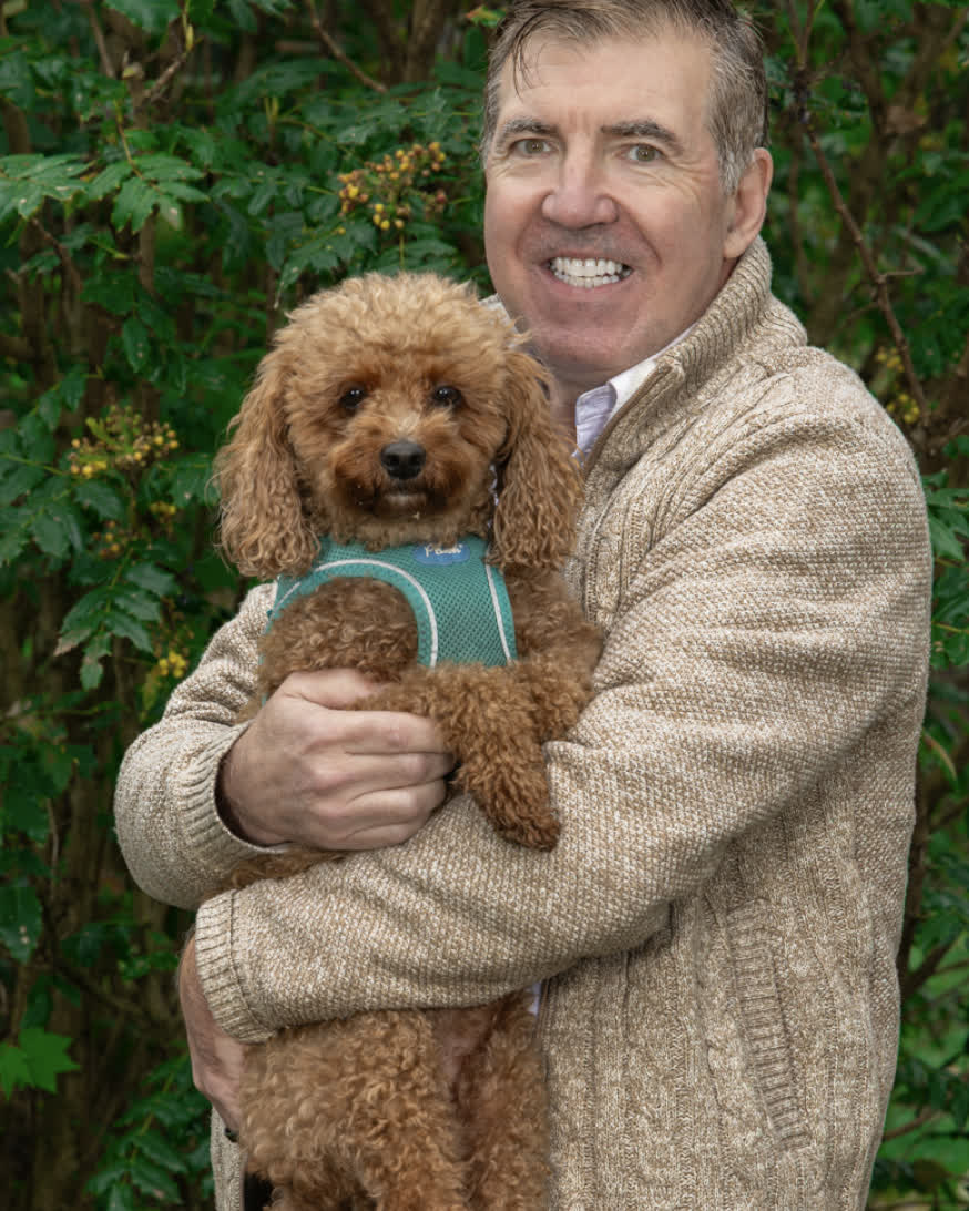 Brooks Friedland outside in Birch Bay, holding his dog.